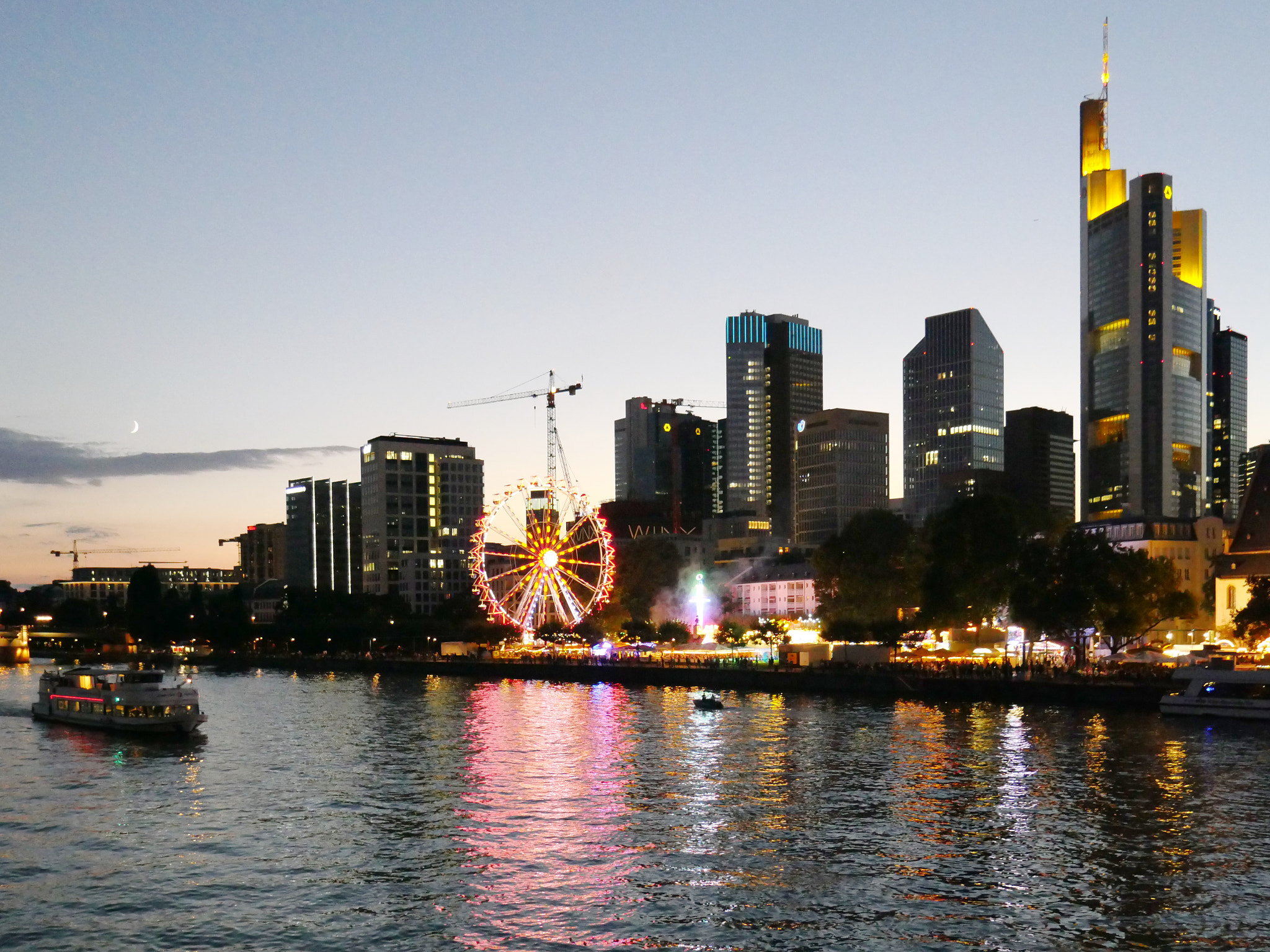 Panoramic view of Frankfurt's modern skyline with skyscrapers and the Main River.